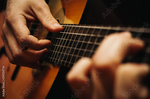 man hands playing classical guitar