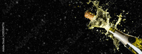 Celebration theme with splashing champagne on black background with snow and free space. Christmas or New Year, Valentines day background. Wide banner format party mockup.