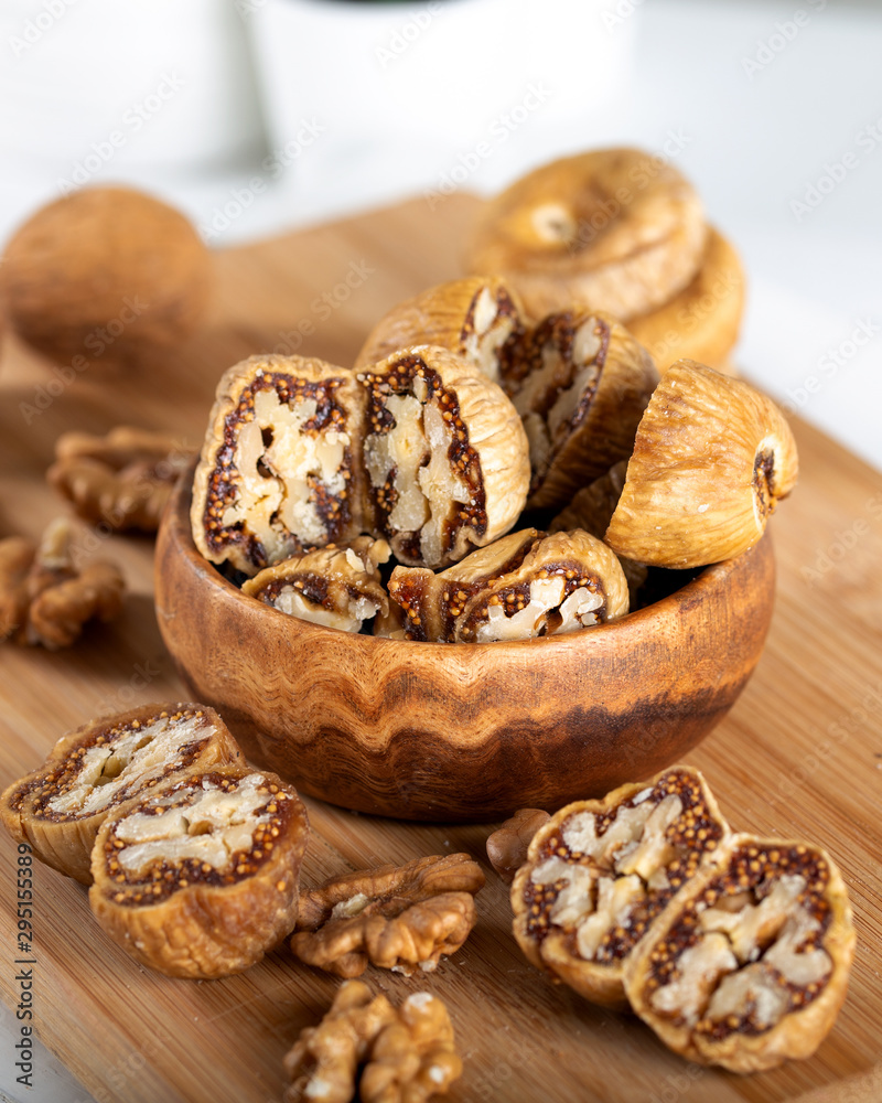 Dried figs with walnuts in wooden bowl. Dried figs with walnuts in wooden bowl.