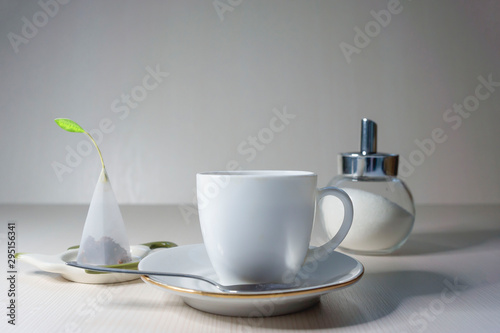 Cuadro en lienzo On a light table is a white cup of fruit tea.