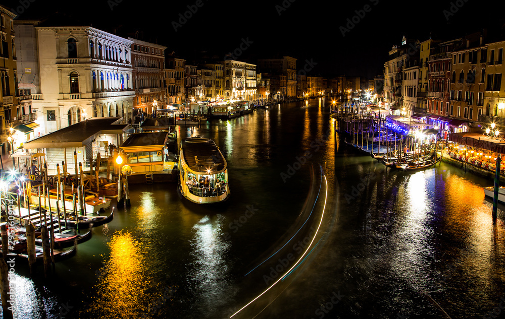 View from Rialto bridge at night in Venice, Italy. Long exposure