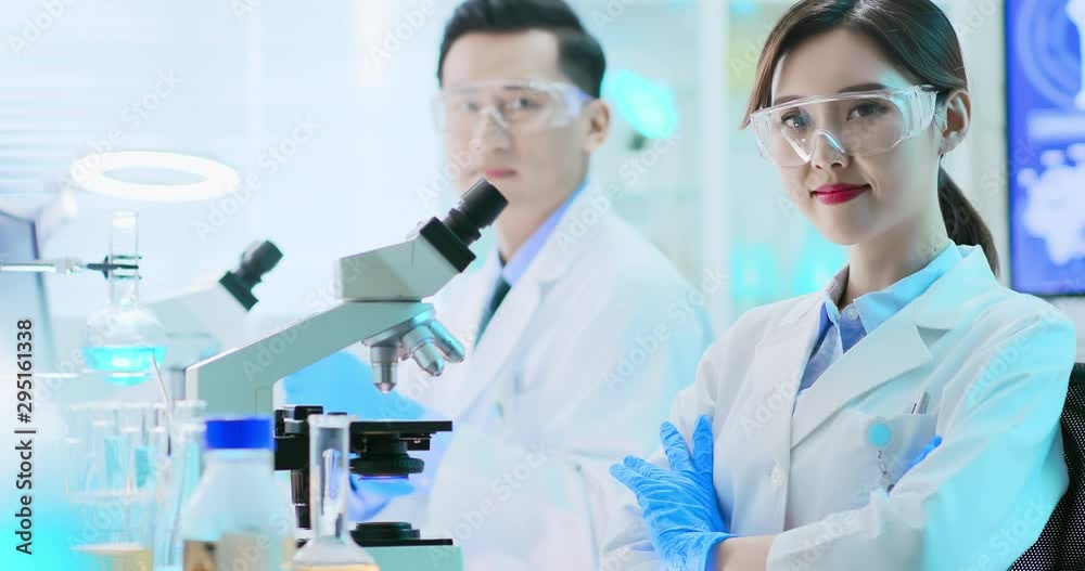 Asian scientist use microscope Asian scientist use microscope