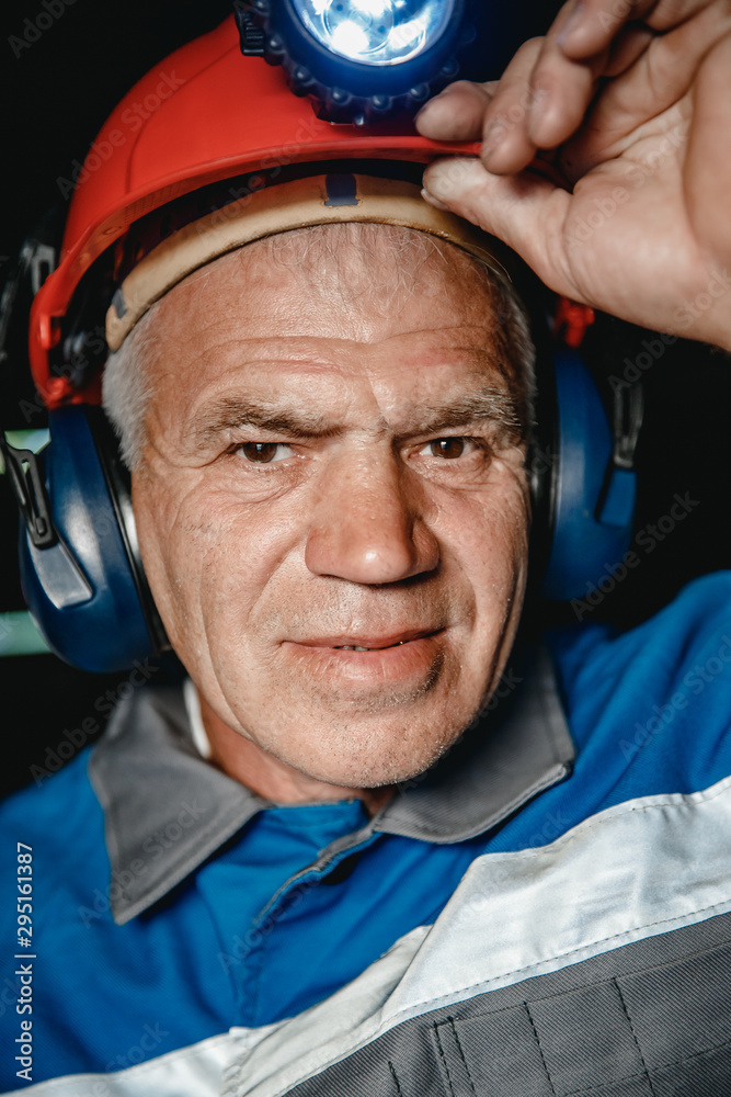 Portrait happy man miner after working in coal mine, dirty face in helmet. Concept vocation industrial worker Portrait happy man miner after working in coal mine, dirty face in helmet. Concept vocation industrial worker