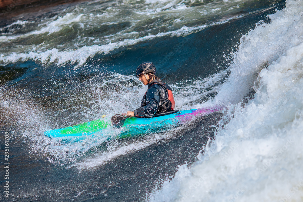 Whitewater kayaking, extreme sport rafting. Guy in kayak sails mountain river