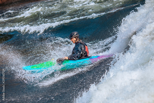 Whitewater kayaking, extreme sport rafting. Guy in kayak sails mountain river © Parilov