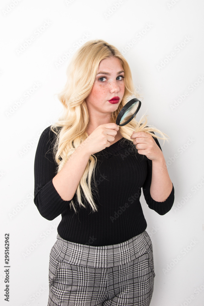 skin care concept, young woman, blonde girl holding magnifier over her face, blue eyes and freckle face skin care concept, young woman, blonde girl holding magnifier over her face, blue eyes and freckle face