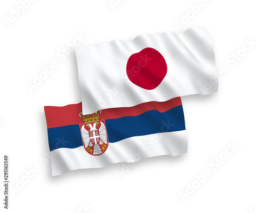 National vector fabric wave flags of Japan and Serbia isolated on white background. 1 to 2 proportion.