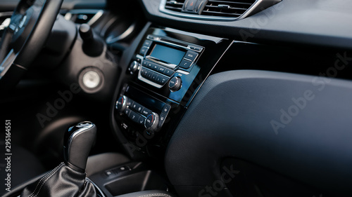 Car detailing. Dashboard. Media, climate and navigation control buttons. Sound system. Modern car interior details.