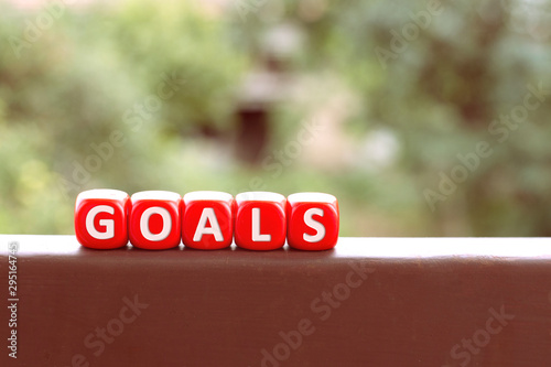 Setting goals concept. Red dices with letters. Taking risks, gambling, symbolism