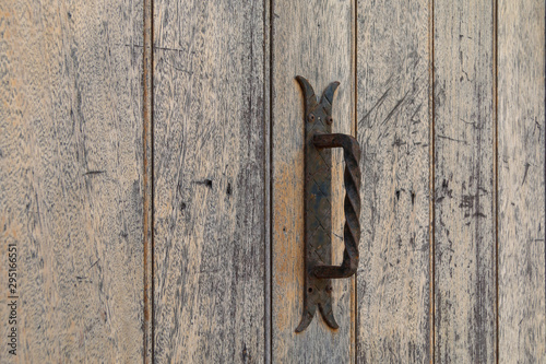 Old iron rusty handle on wooden doors