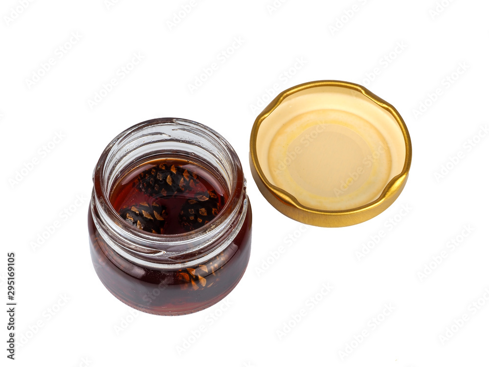 Young pine cones jam in a jar on a white background Young pine cones jam in a jar on a white background