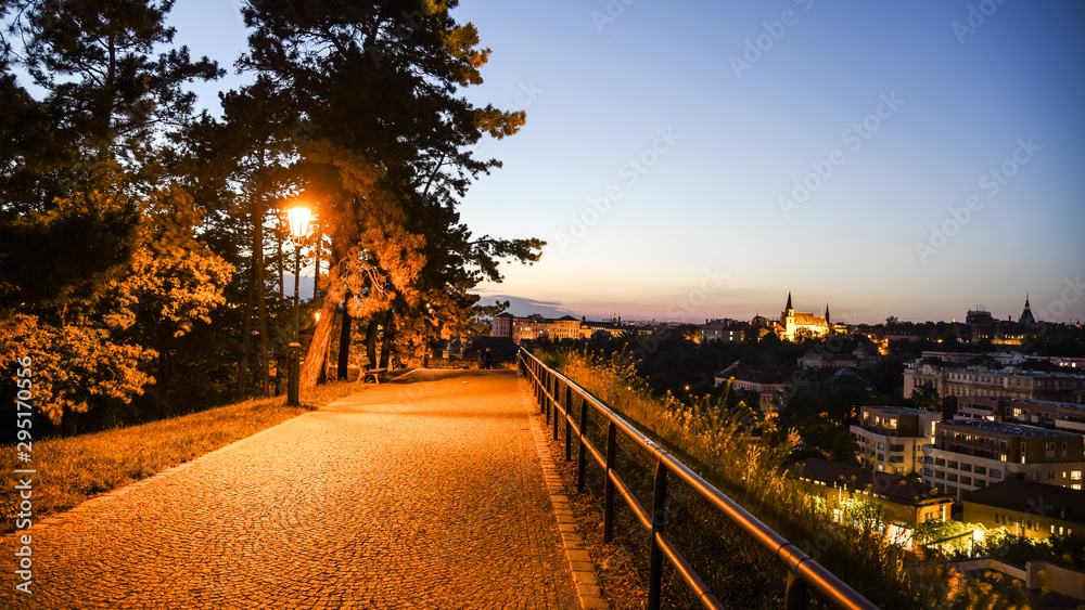 Walkway on Vysehrad fortification walls illuminated by street lamps by night. Prague, Czech Republic