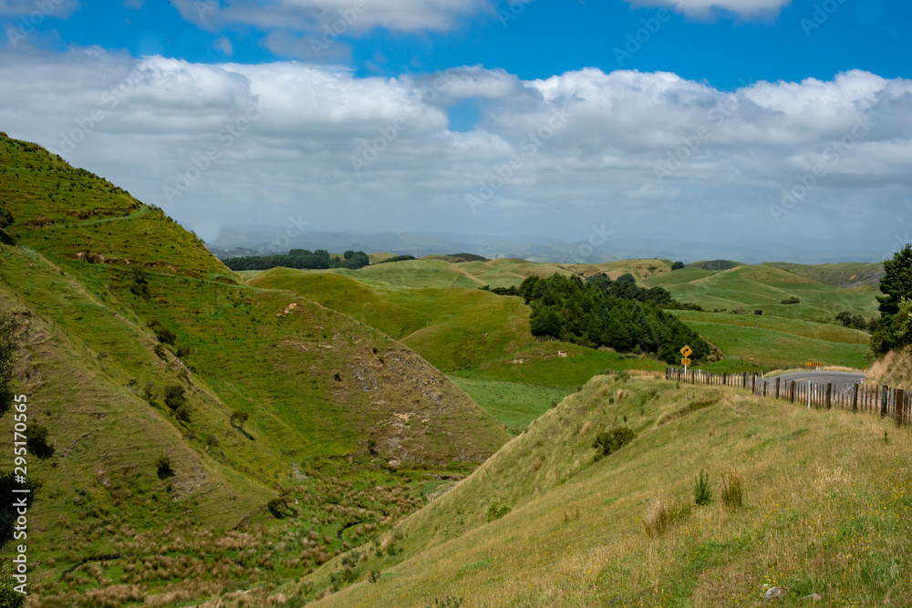Country road winding its way through rural remote countryside in New Zealand