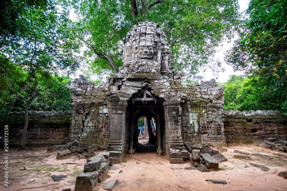 Siem Reap / Cambodia - May 27 / 2019 : entrance door with huge head at ta som temple at angkor wat temple complex