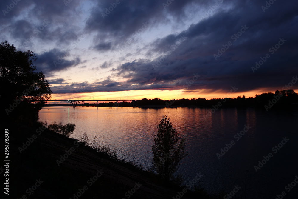 Sunset over river with bridge at Dubna in Russia in autumn