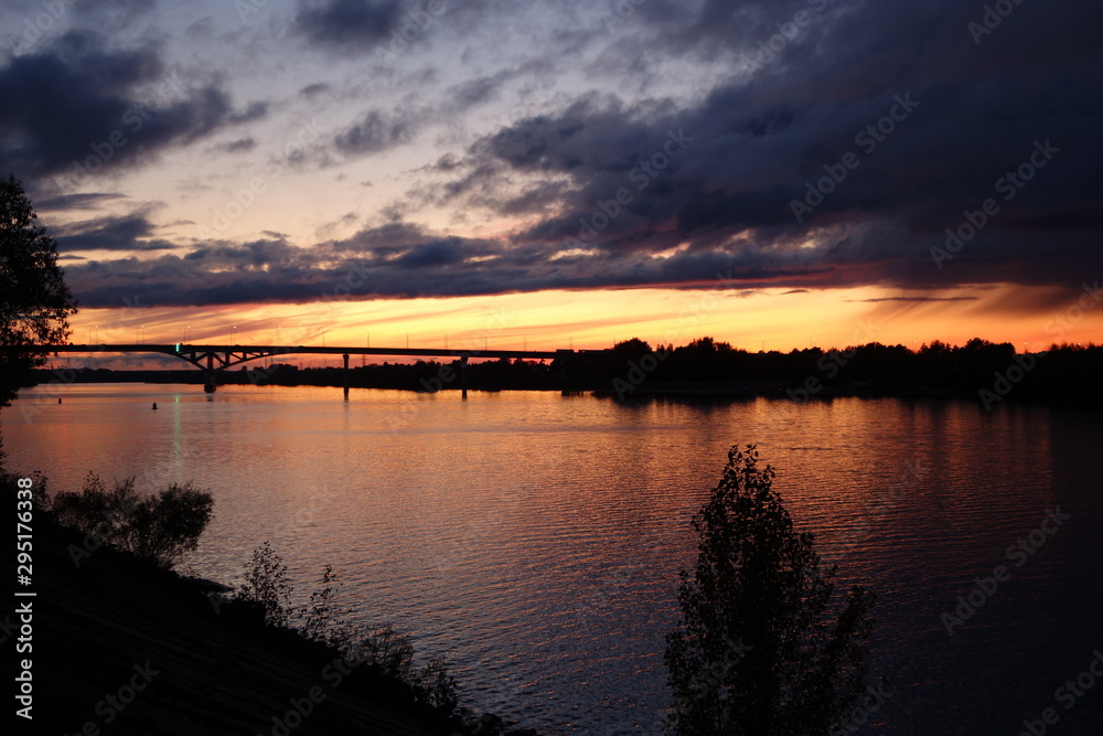 Sunset over river with bridge at Dubna in Russia in autumn