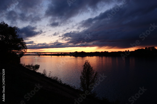 Sunset over river with bridge at Dubna in Russia in autumn