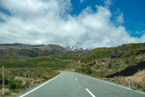 Highway winding its way through the hills and the extreme terrain of the volcanic desert Road in NZ