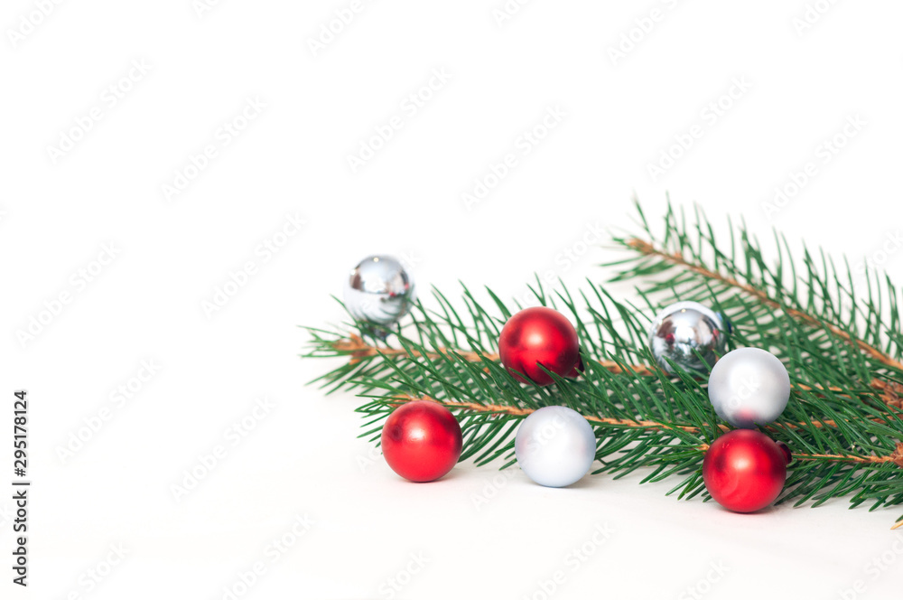 Christmas background with red christmas ornaments on white background with xmas tree branches. Merry christmas greeting card, banner. Winter holiday xmas theme. Happy New Year. Space for text Christmas background with red christmas ornaments on white background with xmas tree branches. Merry christmas greeting card, banner. Winter holiday xmas theme. Happy New Year. Space for text