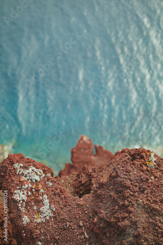 A top down of a cliff into the ocean photo