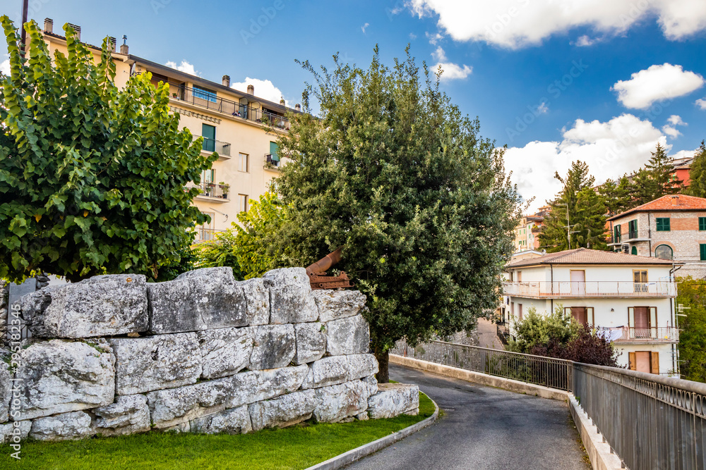 Bellegra, Rome, Lazio, Italy - A small public garden in the center of Bellegra, bordered by the ancient polygonal walls of the city. Trees and large blocks of stone.