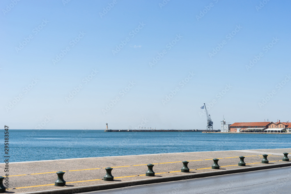 Nikis street in thessaloniki view to the sea and harbor port from the sidewalk in sunny day