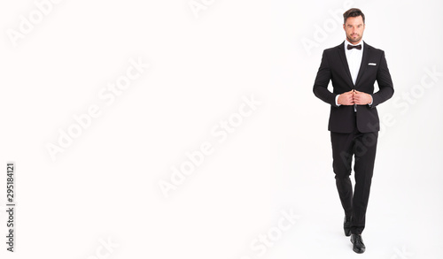 Fotografia Handsome man in classic black suit looks very elegant.