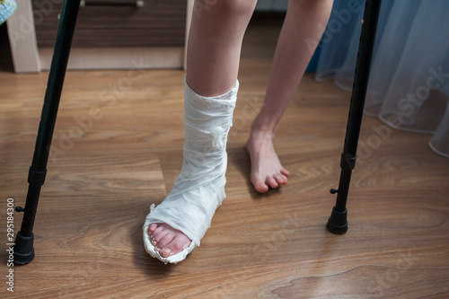 Broken leg in plaster and crutches