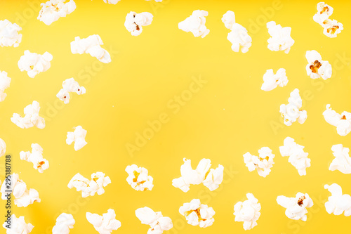 Scattered popcorn over yellow background