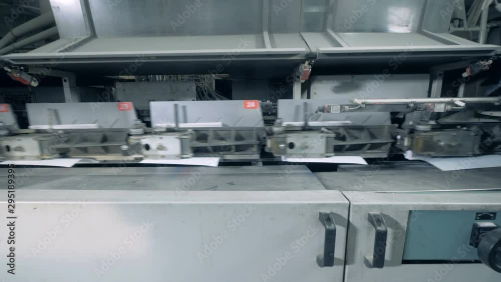 Backs of books are getting produced by the printing machine Backs of books are getting produced by the printing machine