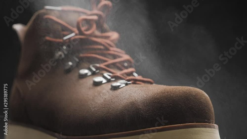 A waterproof spray is applied to the shoes