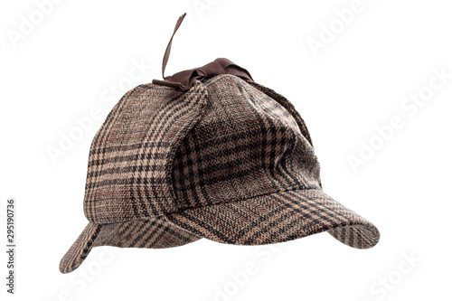 Vintage investigator and retro inspector conceptual idea with deerstalker type hat or Sherlock Holmes cap isolated on white background with clipping path cutout using ghost mannequin technique photo