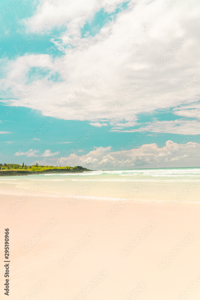 Tropical beach with turquoise ocean waves and white sand. Holiday, vacation, paradise, summer vibes. Shot in Tortuga Bay, San Cristobal, Galapagos Islands.