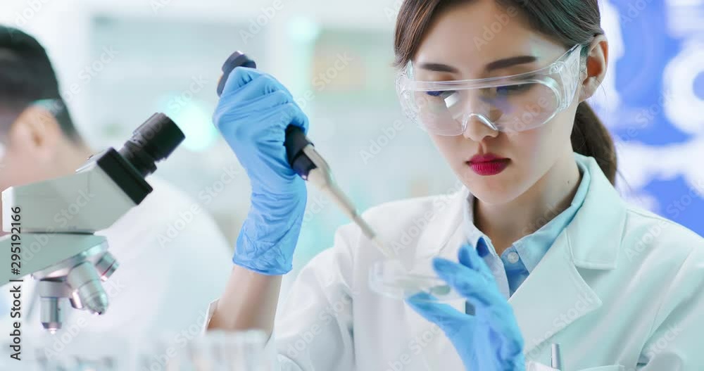 Asian scientist take petri dish Asian scientist take petri dish