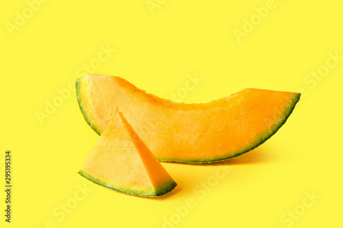 Slices of ripe melon on color background