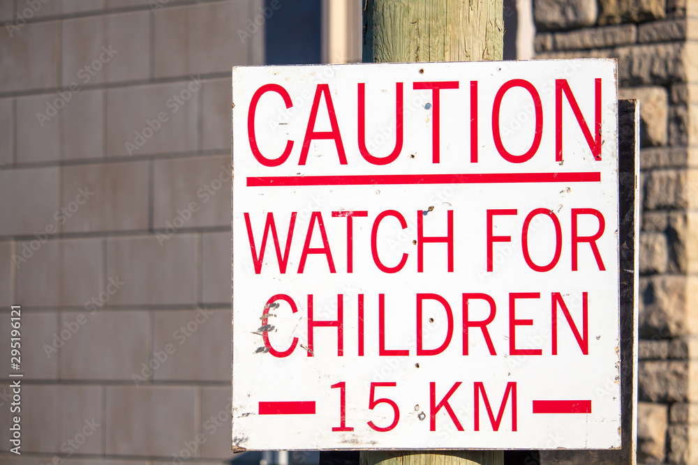 Caution: A sign warns to watch for children and sets a speed limit