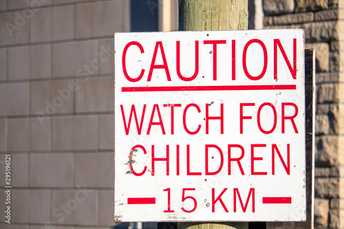 Caution: A sign warns to watch for children and sets a speed limit