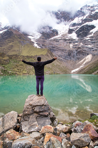 man in front of the Humantay Lake on the Salkantay Trail, the trek to Machu Picchu, Peru