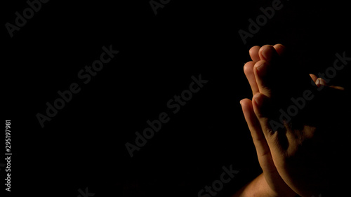 Closeup portrait of a young caucasian man praying