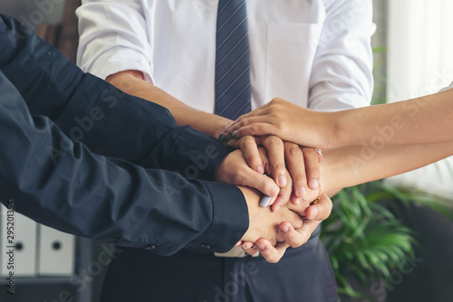 Hand stack and hold together in team for success something or take care.
