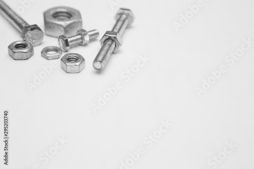 Many nuts and bolts on white background