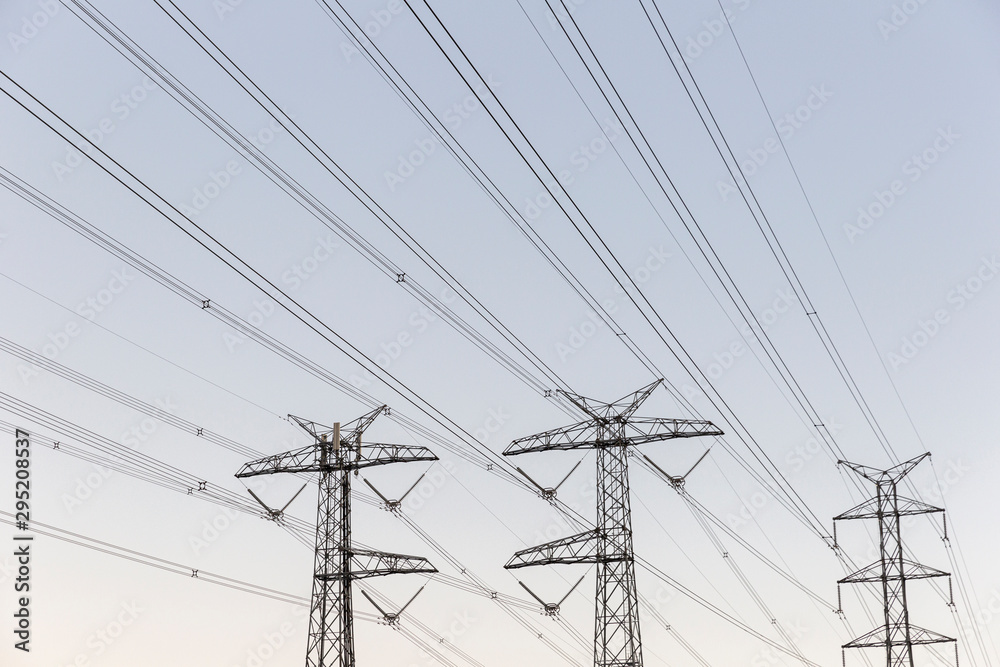 Electricity pylons on soft gradient sky background. Electricity pylons on soft gradient sky background.