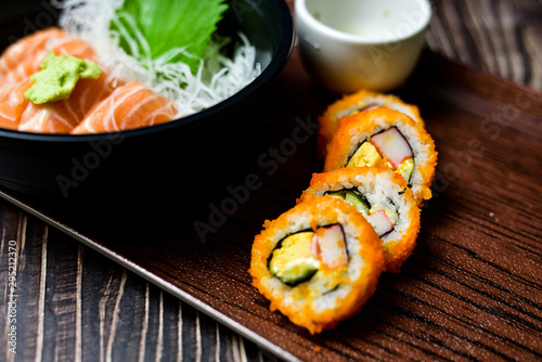 Salmon Sushi is a popular dish in Asia. Black bowl with chopsticks on the table, the concept of restaurant business.