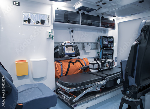 Interior of an ambulance with bed and patient medical care first aid equipment