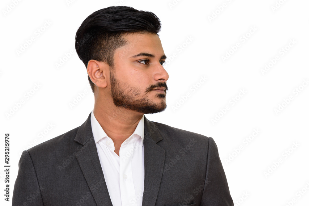 Side view of young handsome Indian businessman Side view of young handsome Indian businessman