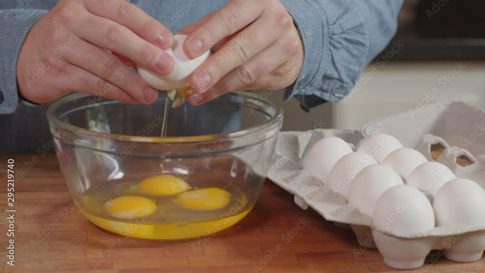 Cracking multiple eggs into a glass bowl Slow Motion Cracking multiple eggs into a glass bowl Slow Motion