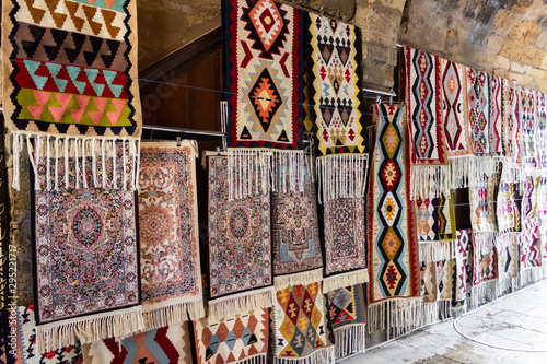 Street bazaar of ancient oriental handmade Garabagh, Tabriz, Shirvan style carpets, rugs at Old Town Baku, Azerbaijan