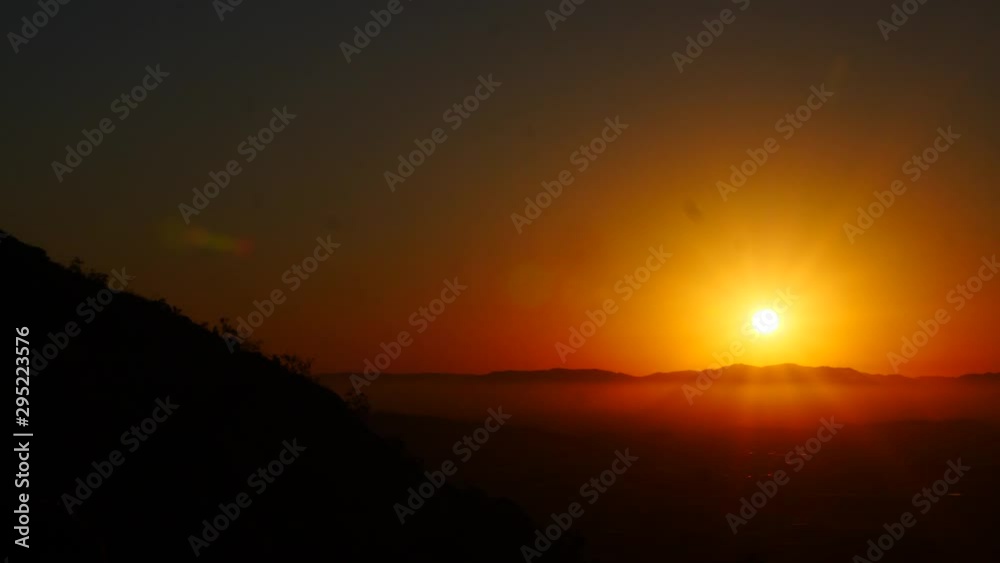 beautiful golden sunset with fog at the top of mountain, Townsville, Castle Hills, Australia beautiful golden sunset with fog at the top of mountain, Townsville, Castle Hills, Australia