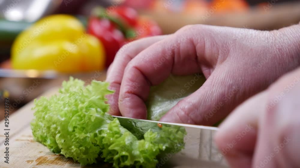 a hand cut salad on a wooden cutting board a hand cut salad on a wooden cutting board