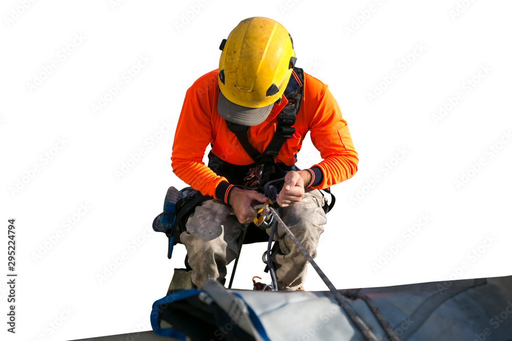 Close up pic of male rope access jobs worker wearing yellow hard hat, long sleeve shirt, safety harness, working, at height abseiling down from high rise building with isolated white background Close up pic of male rope access jobs worker wearing yellow hard hat, long sleeve shirt, safety harness, working, at height abseiling down from high rise building with isolated white background